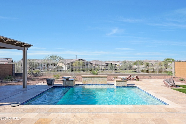 view of swimming pool featuring pool water feature and a patio area