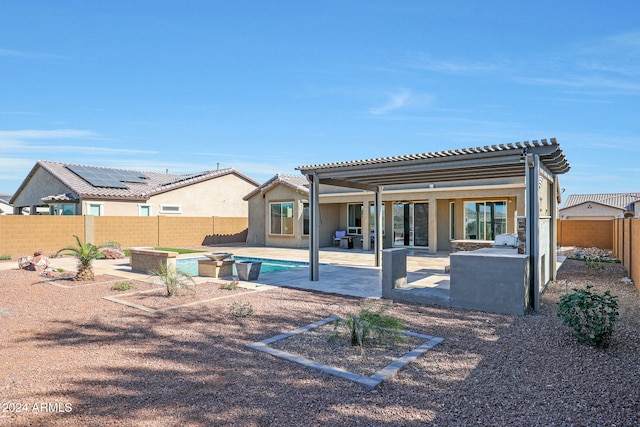 rear view of property featuring a pergola, a patio area, and a fenced in pool