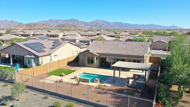 16918 S 180th Dr, Goodyear, AZ 85338 - rear view of house featuring a fenced in pool, a residential view, a fenced backyard, and stucco siding