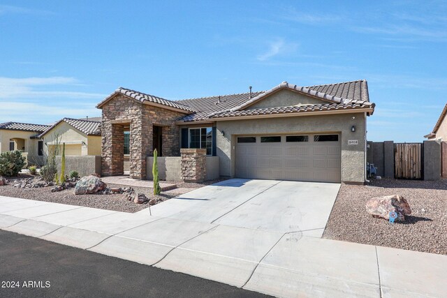 16918 S 180th Dr, Goodyear, AZ 85338 - single story home with stucco siding, an attached garage, a tile roof, and stone siding