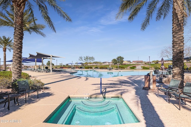 view of pool featuring a hot tub and a patio area