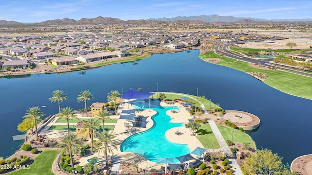 drone / aerial view featuring a water and mountain view