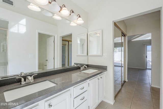 full bath with a sink, visible vents, a stall shower, and tile patterned floors