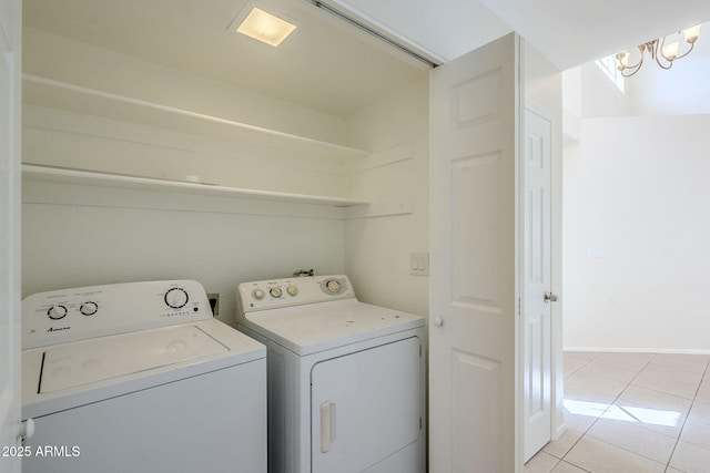 washroom featuring washing machine and clothes dryer, laundry area, and light tile patterned flooring