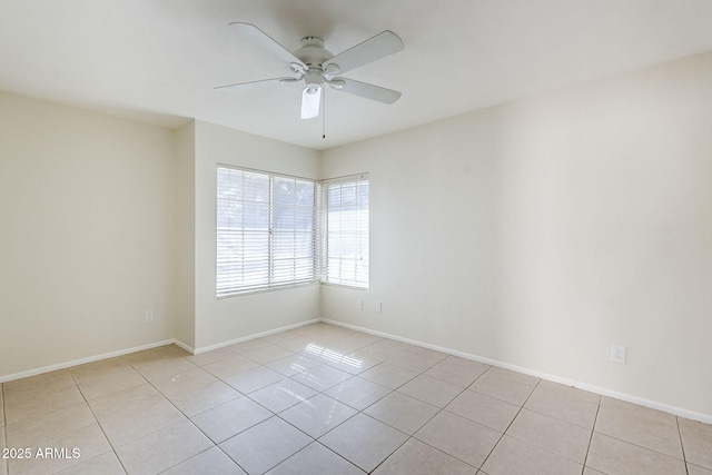 unfurnished room featuring light tile patterned flooring, baseboards, and ceiling fan