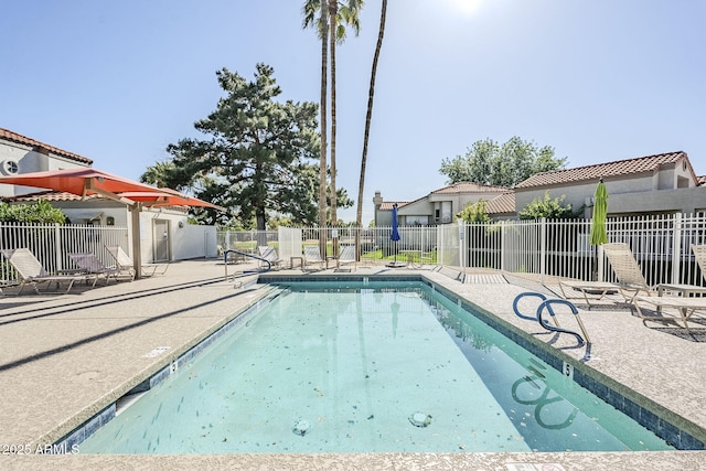 pool featuring a patio and fence