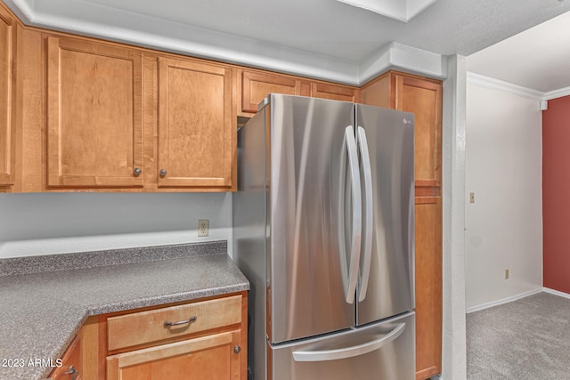 750 E Northern Ave Unit 2045, Phoenix, AZ 85020 - kitchen with freestanding refrigerator, ornamental molding, brown cabinetry, carpet flooring, and dark countertops