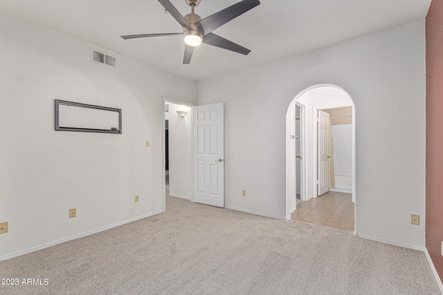 750 E Northern Ave Unit 2045, Phoenix, AZ 85020 - unfurnished bedroom featuring carpet, arched walkways, ceiling fan, and ensuite bathroom