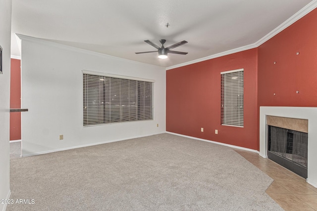 750 E Northern Ave Unit 2045, Phoenix, AZ 85020 - unfurnished living room with ceiling fan, ornamental molding, a fireplace with flush hearth, carpet flooring, and tile patterned flooring