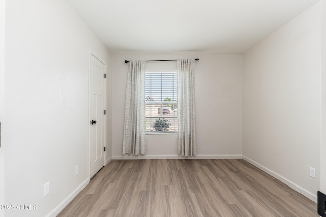 20818 N 21st Dr, Phoenix, AZ 85027 - empty room featuring baseboards and light wood-type flooring
