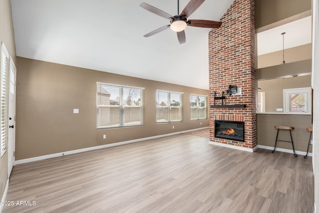 20818 N 21st Dr, Phoenix, AZ 85027 - unfurnished living room with a fireplace, high vaulted ceiling, a ceiling fan, baseboards, and wood finished floors