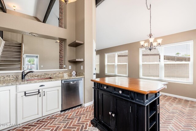 20818 N 21st Dr, Phoenix, AZ 85027 - kitchen featuring stainless steel dishwasher, open shelves, dark cabinetry, and brick floor
