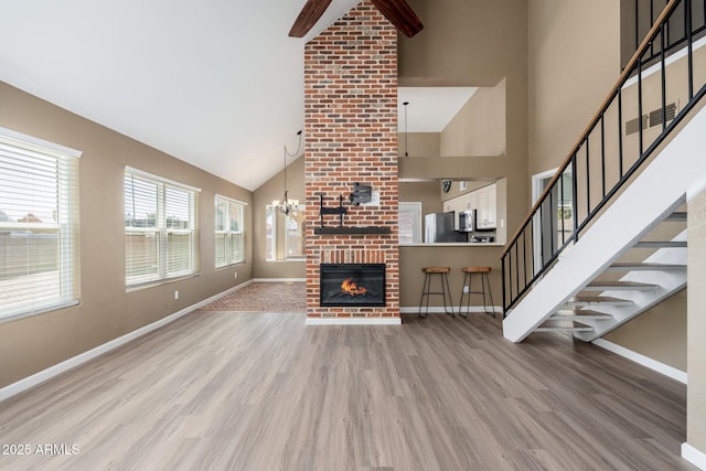20818 N 21st Dr, Phoenix, AZ 85027 - unfurnished living room with light wood-style floors, baseboards, and high vaulted ceiling