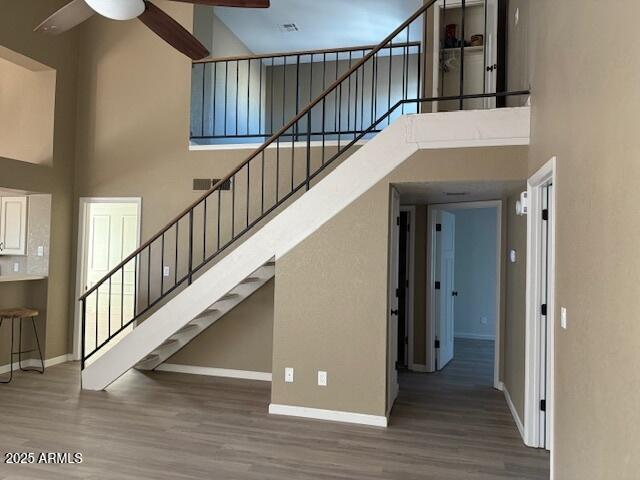 20818 N 21st Dr, Phoenix, AZ 85027 - stairs with baseboards, a ceiling fan, wood finished floors, and a towering ceiling