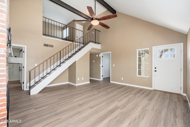 20818 N 21st Dr, Phoenix, AZ 85027 - unfurnished living room with ceiling fan, visible vents, wood finished floors, high vaulted ceiling, and stairs