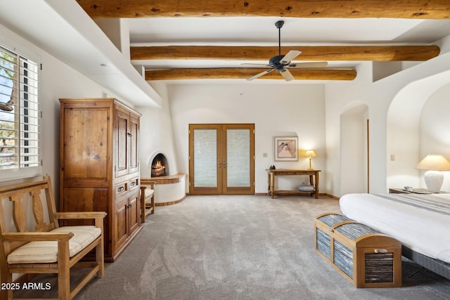 bedroom featuring beamed ceiling, light carpet, access to exterior, and french doors