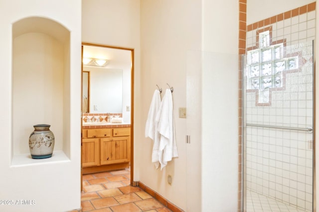 full bathroom featuring vanity, backsplash, and a tile shower