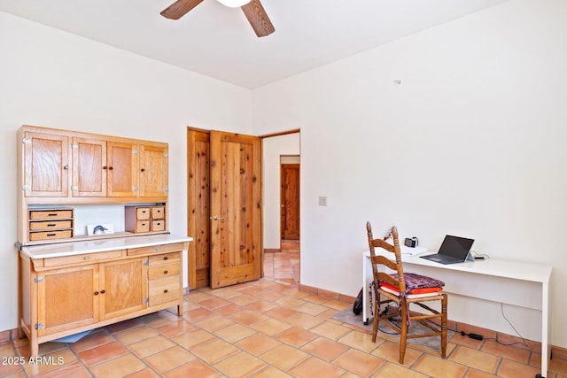 office area featuring light tile patterned flooring, baseboards, and a ceiling fan