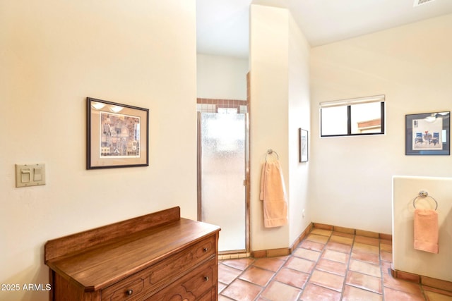 bathroom with tile patterned flooring and baseboards