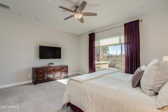 bedroom with ceiling fan and light carpet