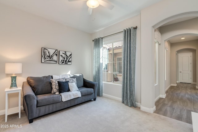 living room featuring ceiling fan and carpet floors