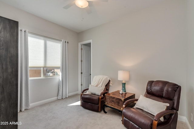 living area with ceiling fan, a healthy amount of sunlight, and light carpet