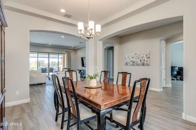 dining room featuring an inviting chandelier and light wood-type flooring