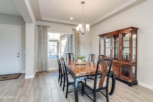 dining room featuring light hardwood / wood-style floors and a notable chandelier