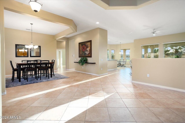 dining room featuring ceiling fan with notable chandelier and light tile patterned floors