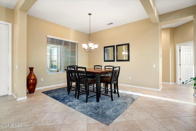 tiled dining space with an inviting chandelier