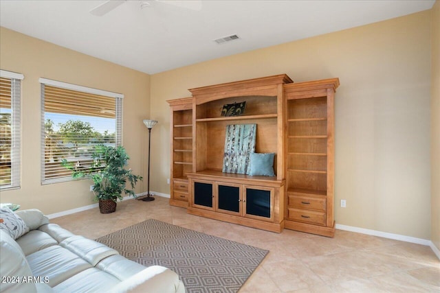 tiled living room featuring ceiling fan