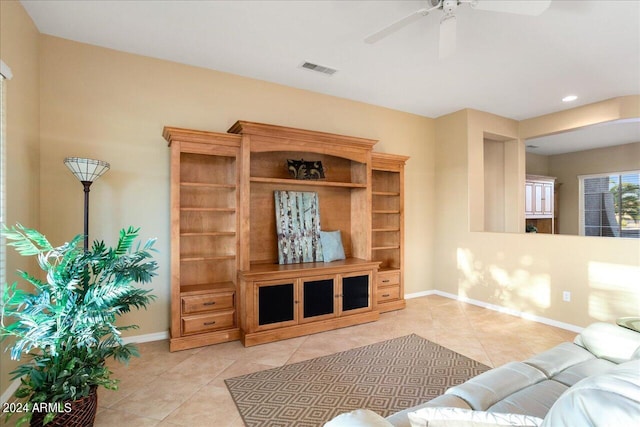 living room with ceiling fan and light tile patterned floors