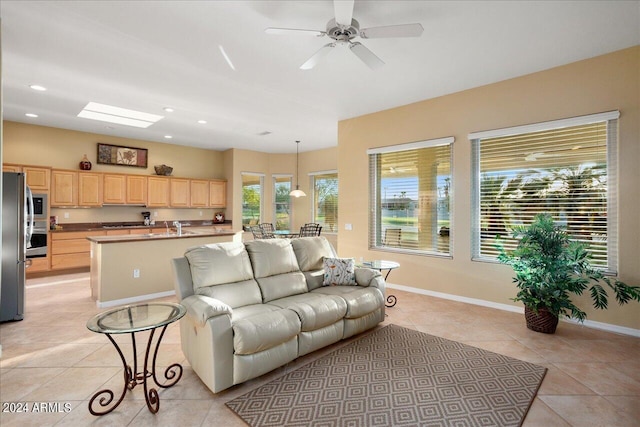 tiled living room featuring sink and ceiling fan