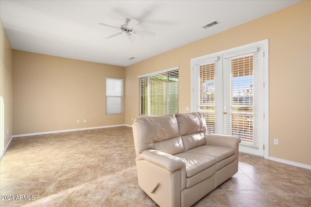 living area featuring light tile patterned floors, ceiling fan, and french doors