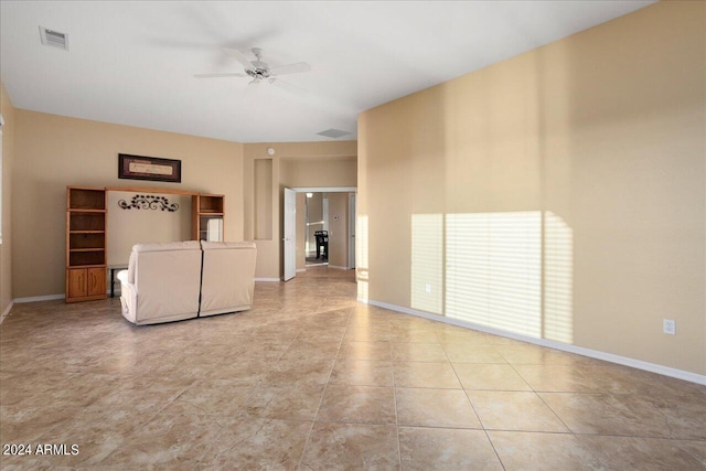 unfurnished living room featuring ceiling fan and light tile patterned floors