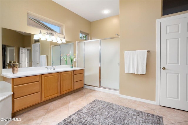 bathroom with vanity, walk in shower, and tile patterned flooring