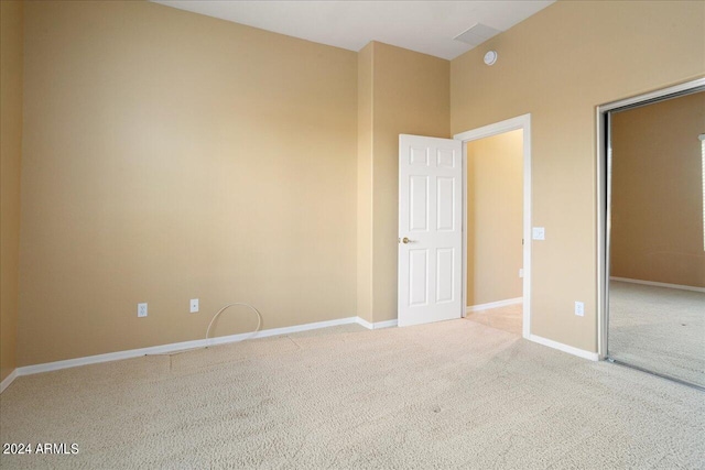 unfurnished bedroom featuring light carpet