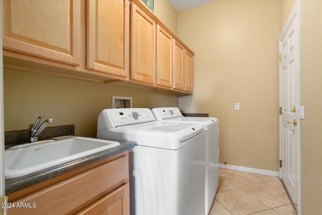 laundry room with sink, light tile patterned flooring, cabinets, and independent washer and dryer