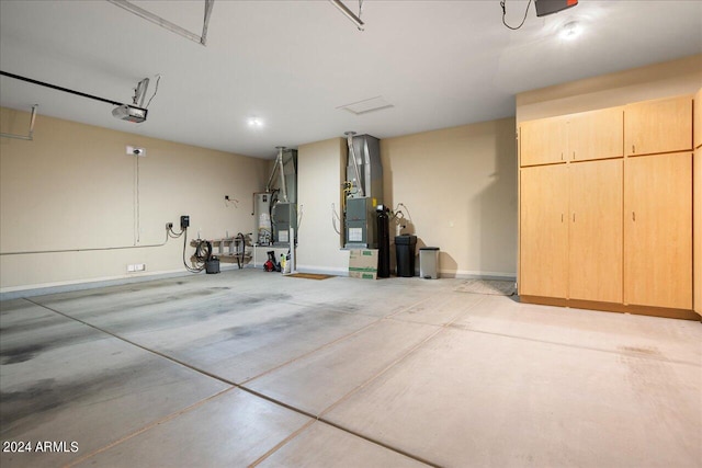 garage with heating unit, water heater, and a garage door opener