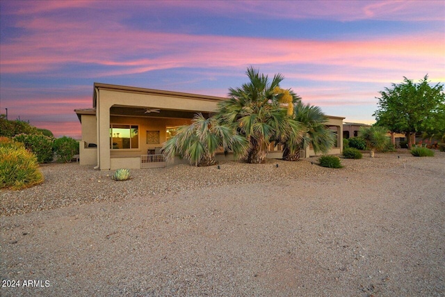 view of back house at dusk