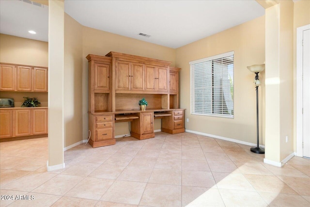 office featuring light tile patterned flooring and built in desk