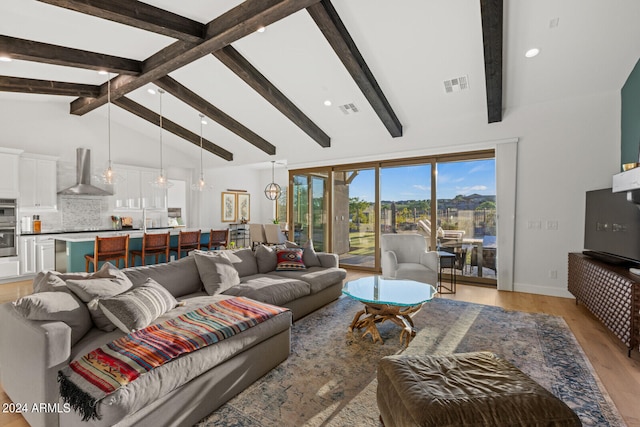 living room featuring high vaulted ceiling, light wood-type flooring, and beam ceiling