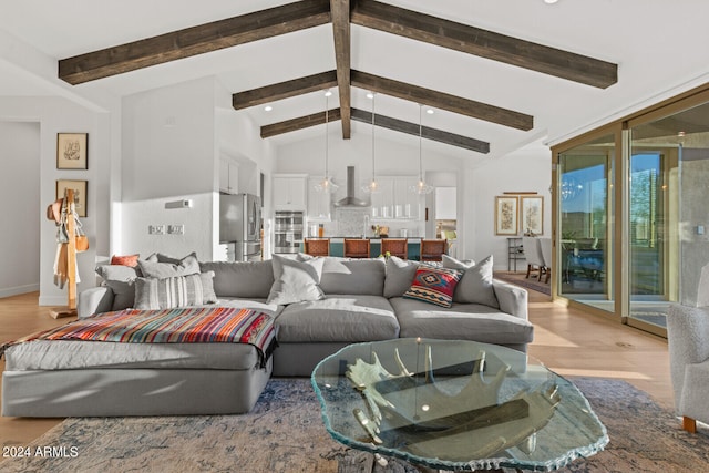 living room with vaulted ceiling with beams and light hardwood / wood-style flooring