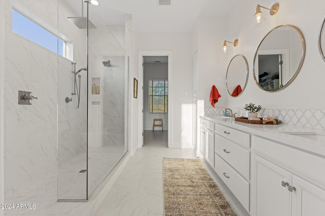 bathroom with tiled shower and vanity