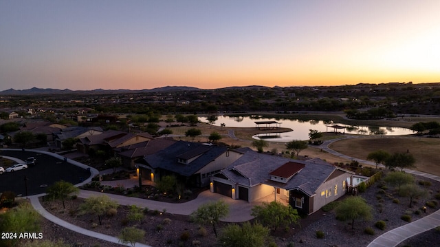 aerial view at dusk with a water view