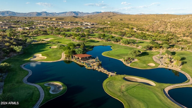 birds eye view of property with a water and mountain view