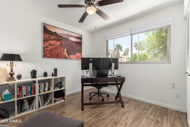 office area with baseboards, a ceiling fan, a textured ceiling, and wood finished floors