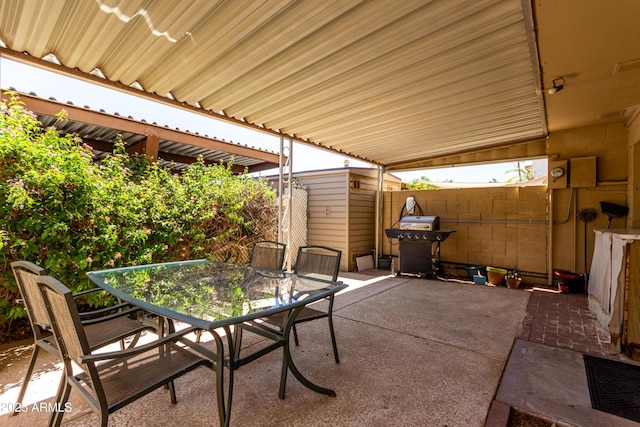 view of patio with fence, outdoor dining area, and area for grilling