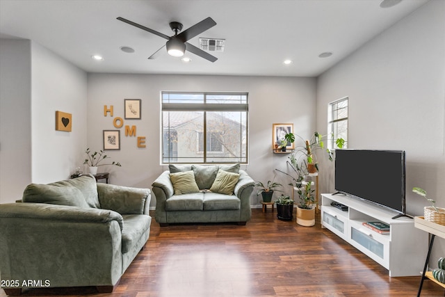 living room featuring ceiling fan and dark hardwood / wood-style flooring