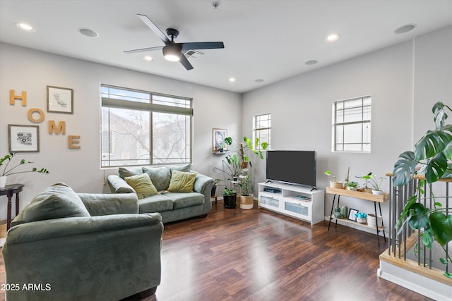 living room with dark hardwood / wood-style flooring and ceiling fan